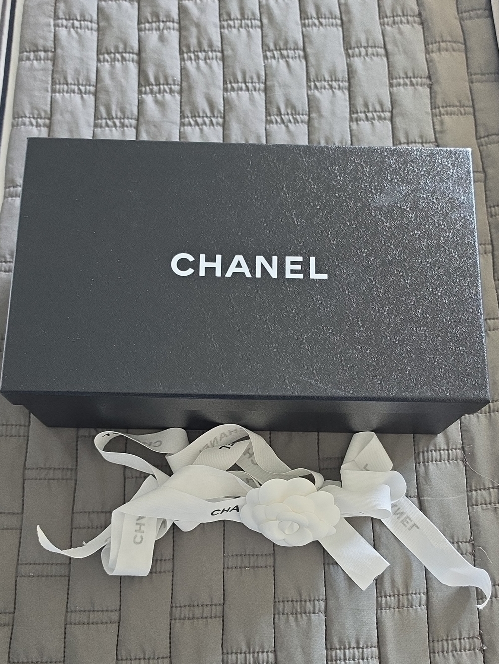 CHANEL Black Box with White Ribbon and Camellia Accent